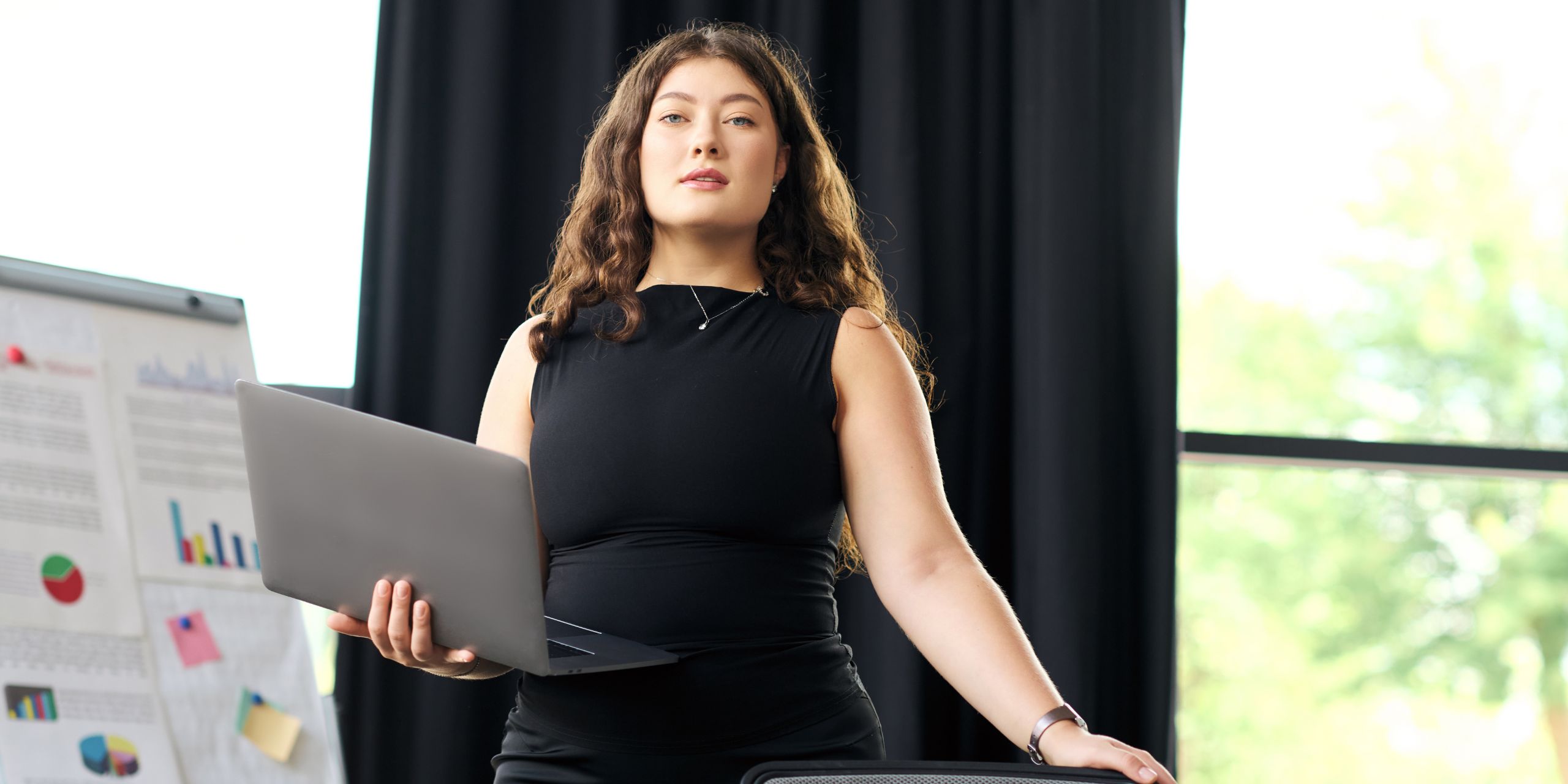 A subject matter expert standing at an office waiting for a meeting to start