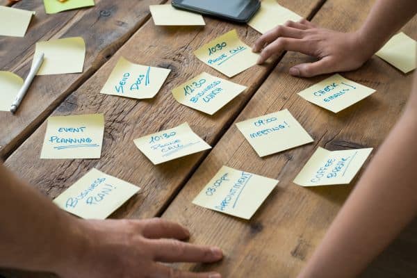 A person organising tasks on a desk