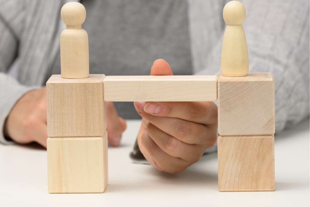 Corporate Employees Building a Bridge During a Kolbs Learning Theory Session