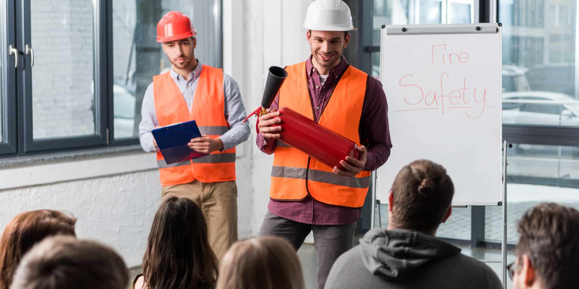 Firefighter-Giving-Office-Employees-Fire-Safety-Training