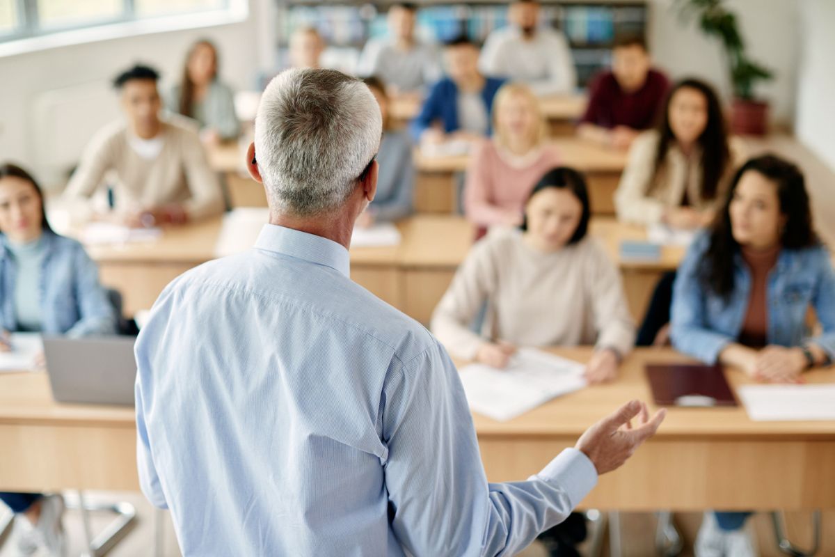 An instructor in a classroom for an in person session
