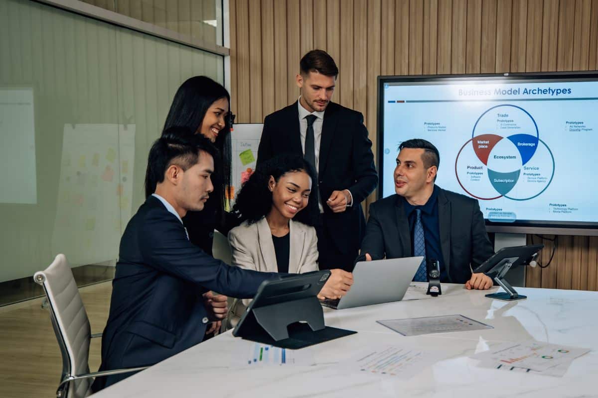 Managers create employee training programs on a laptop