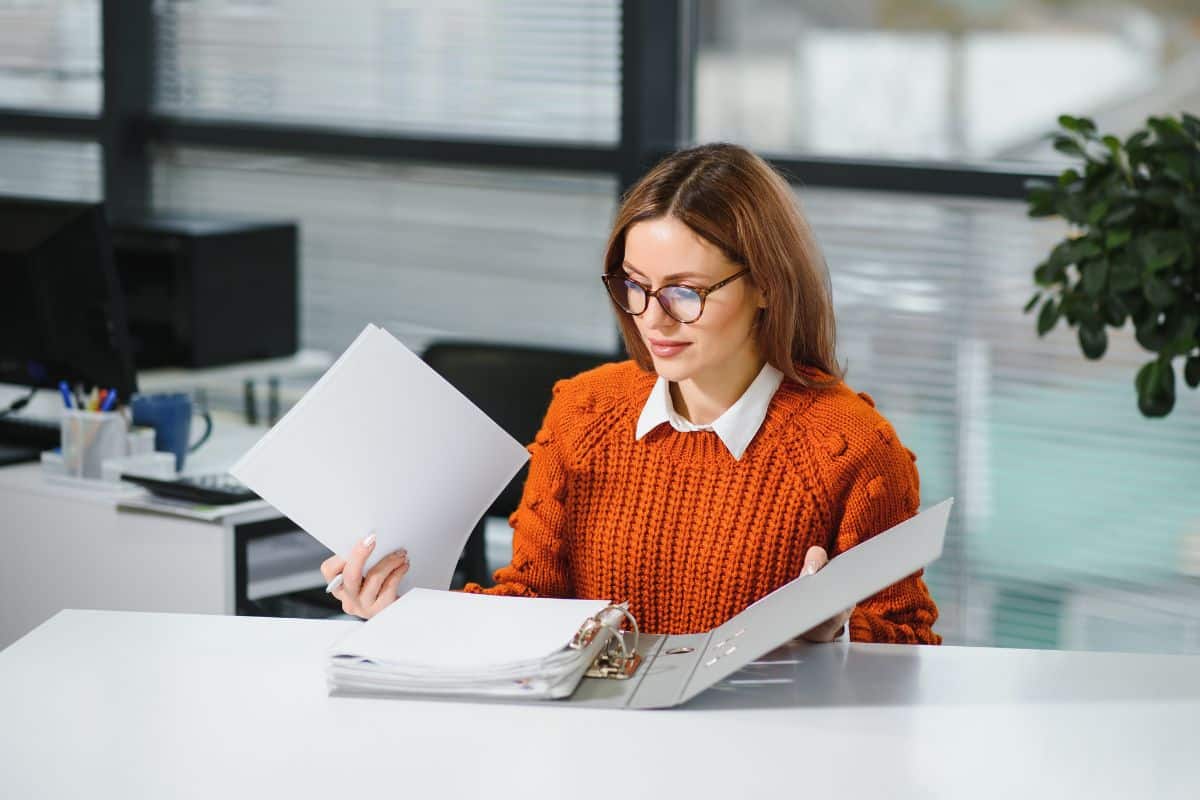 New Employee Going Through Company Documents as Part of their Induction Training