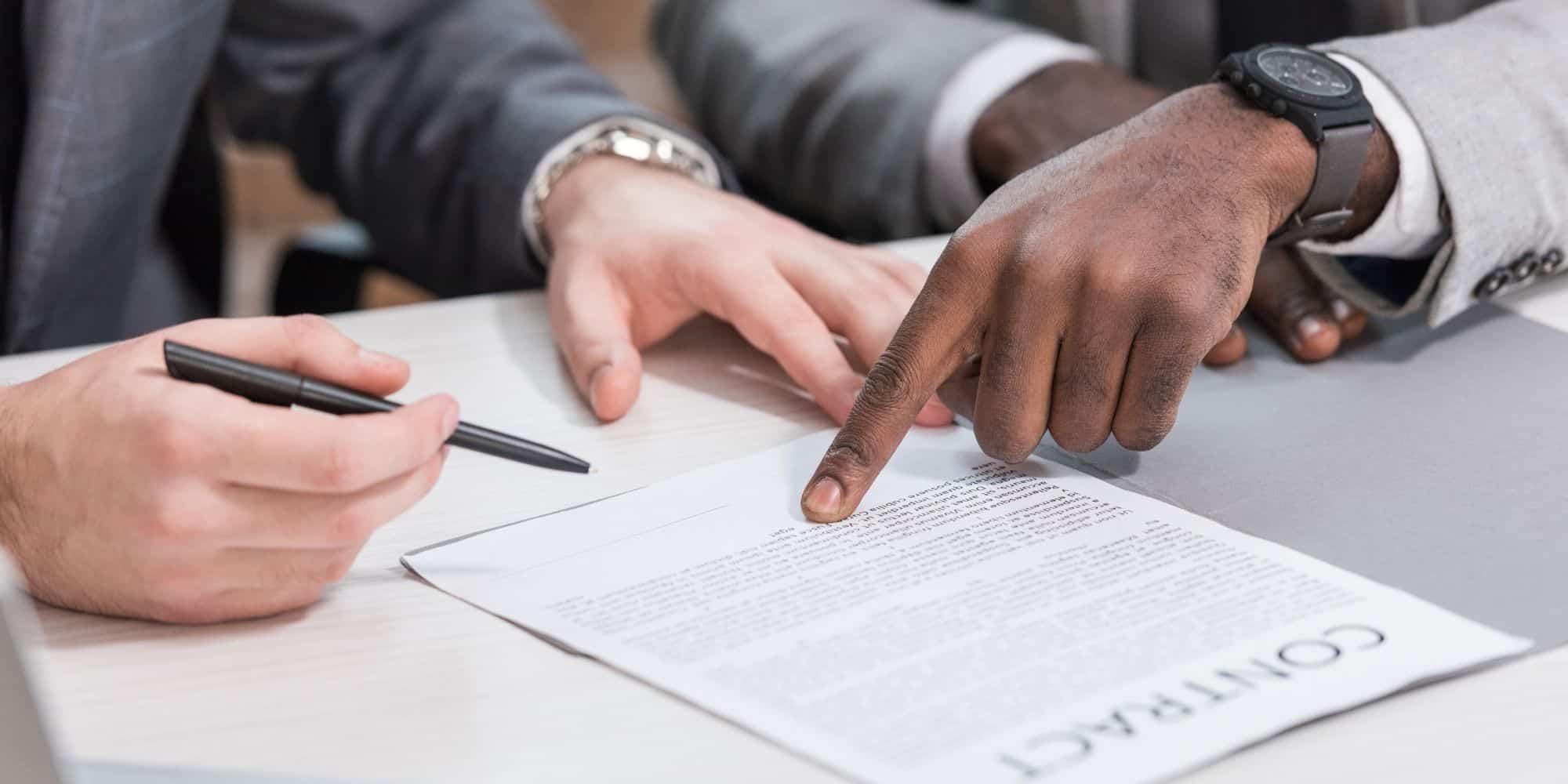Two people working on a contract