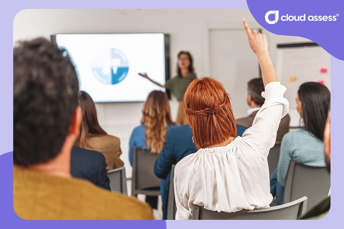 adult learner raises hand during training to answer a question as part of formative assessment