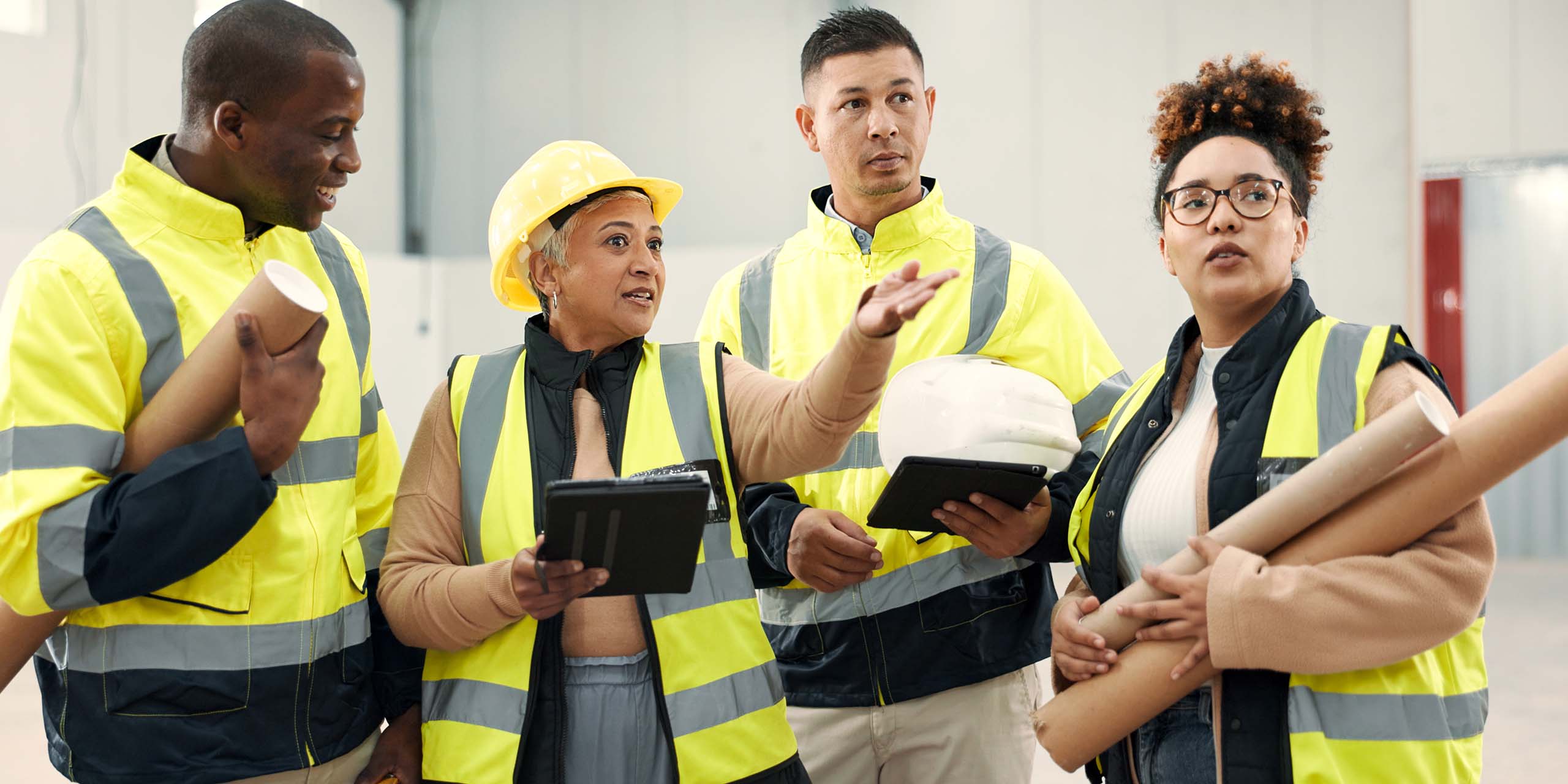 assessor works with onsite team using tablets during on-the-job assessment