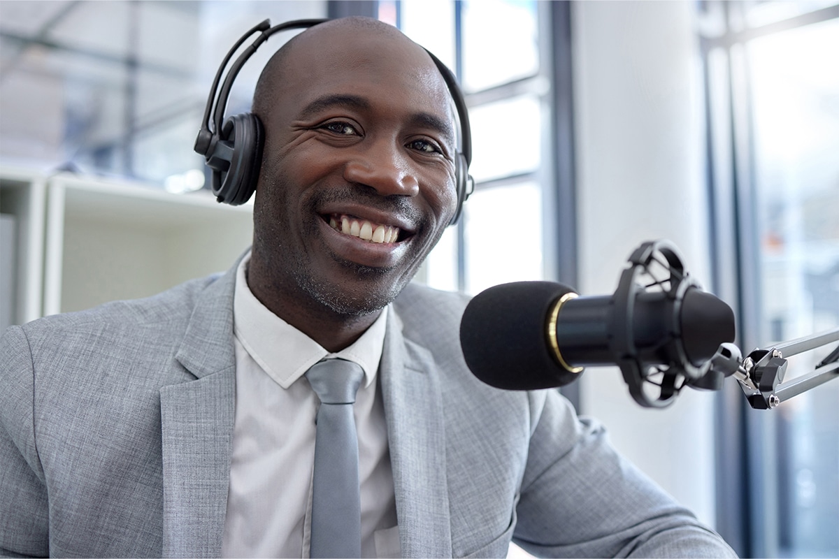 business man talks into microphone on podcast as microlearning example