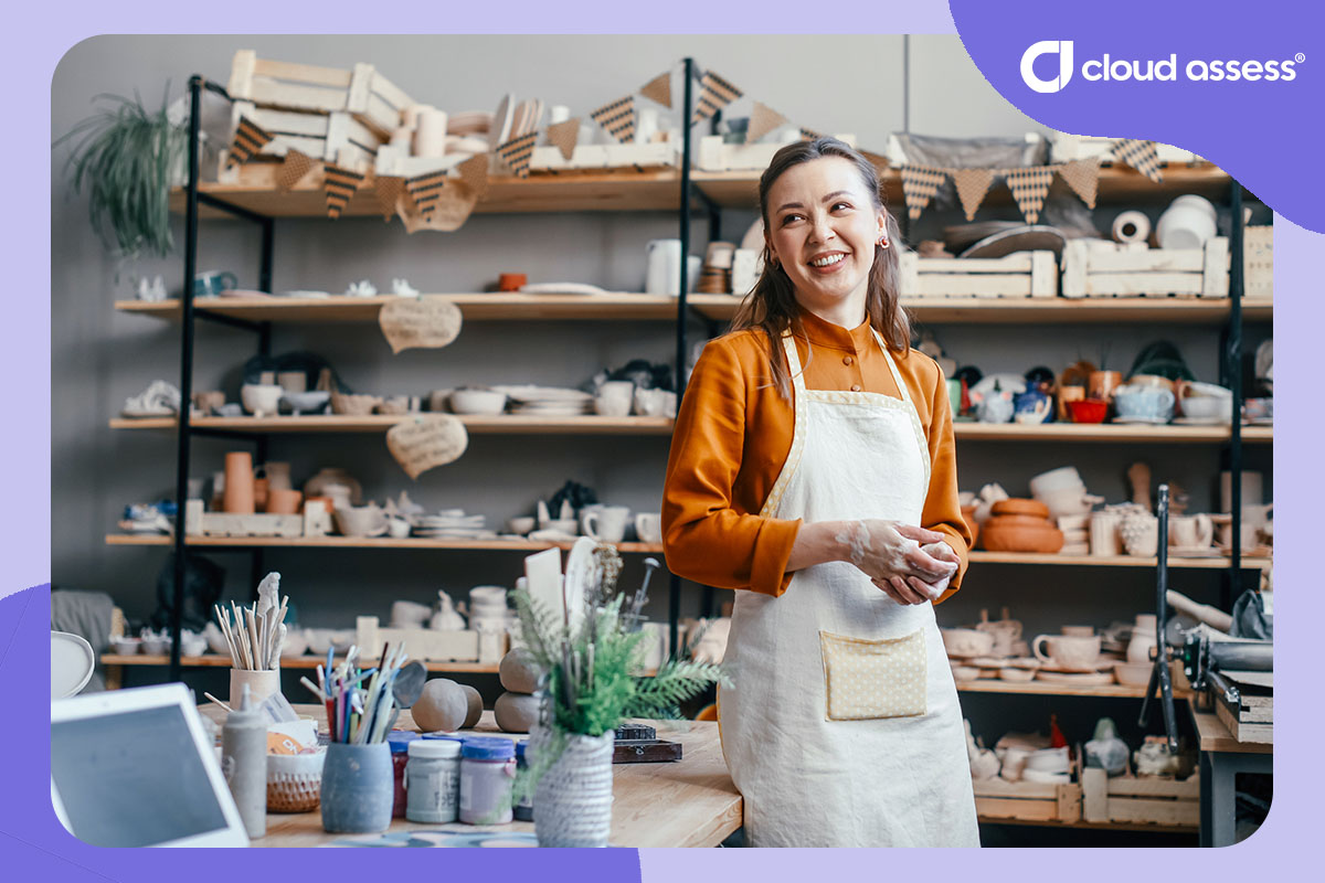 business owner stands in front of pottery products