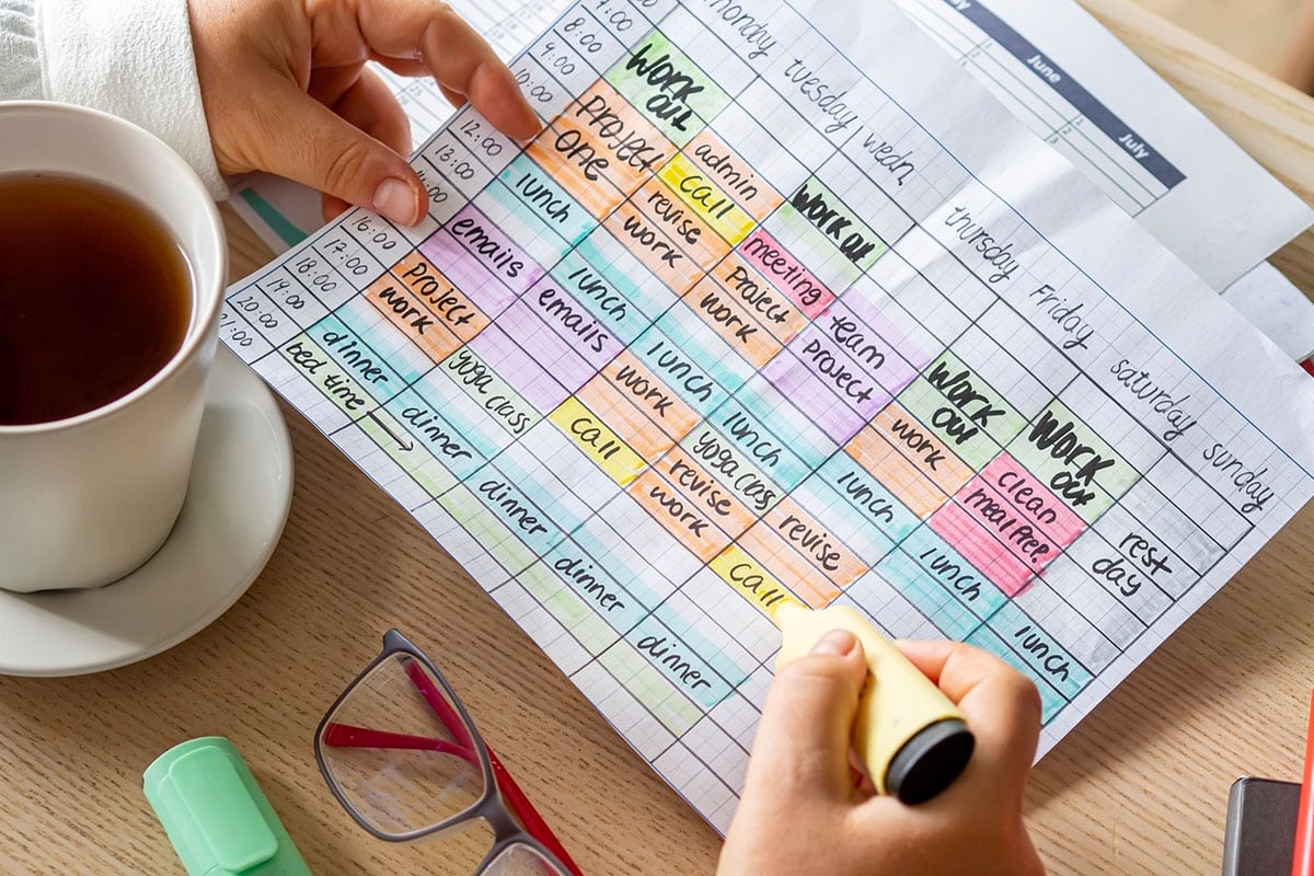 business person plans out week using time management skills