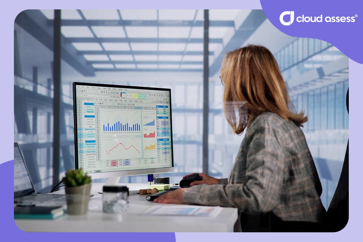 business woman reviews training data in graphs on desktop