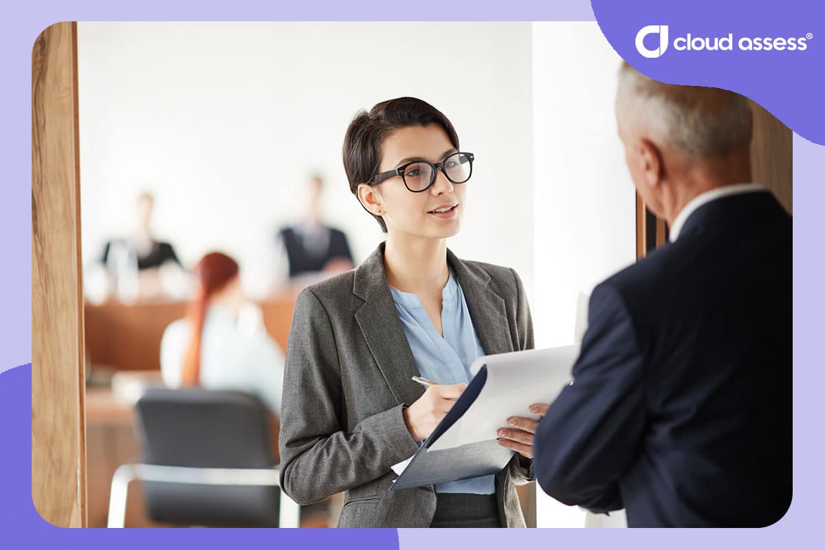 business woman runs through checklist to determine older business mans knowledge as part of diagnostic assessment