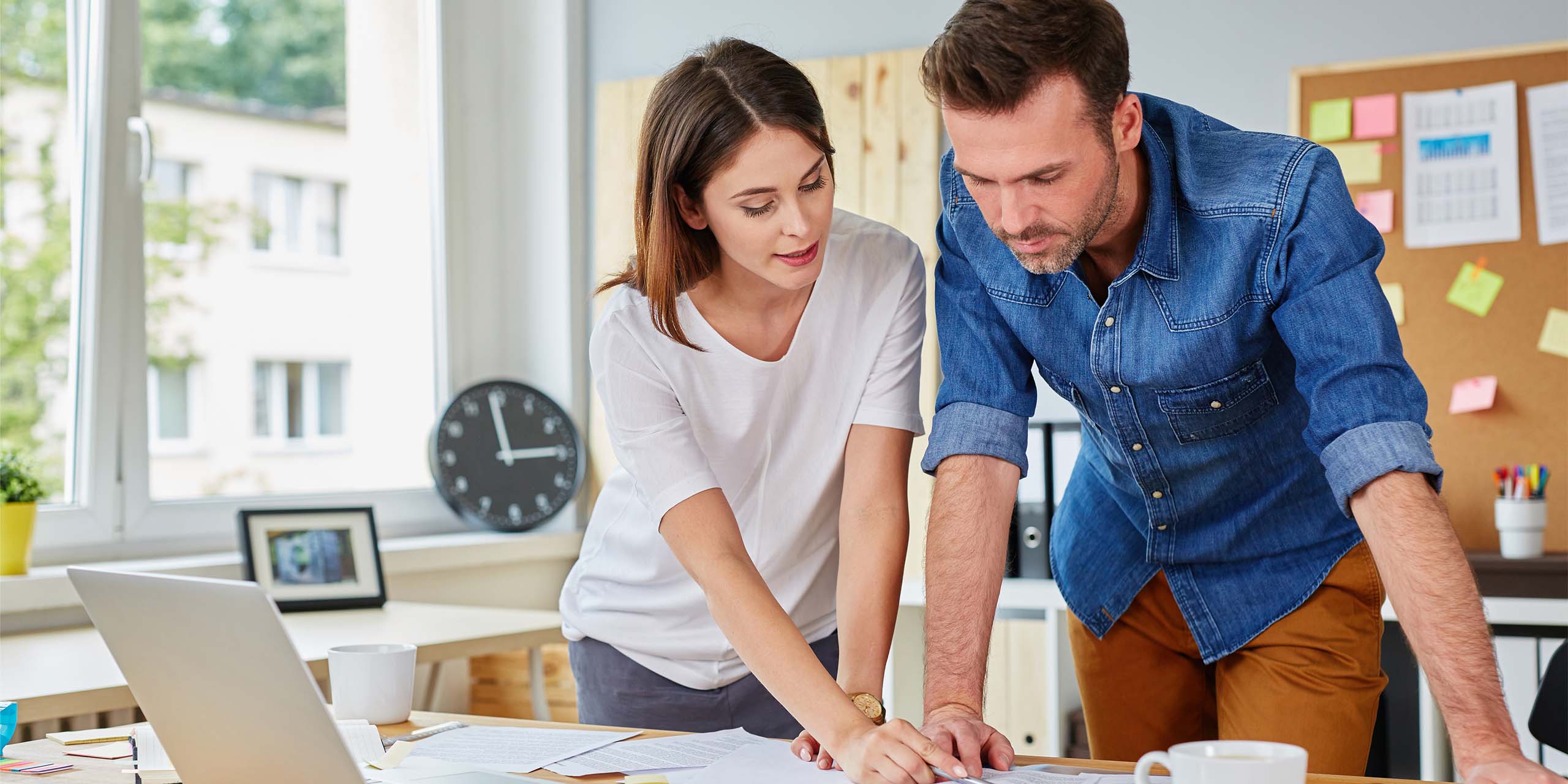 business woman shows colleague her processes in cross training initiative