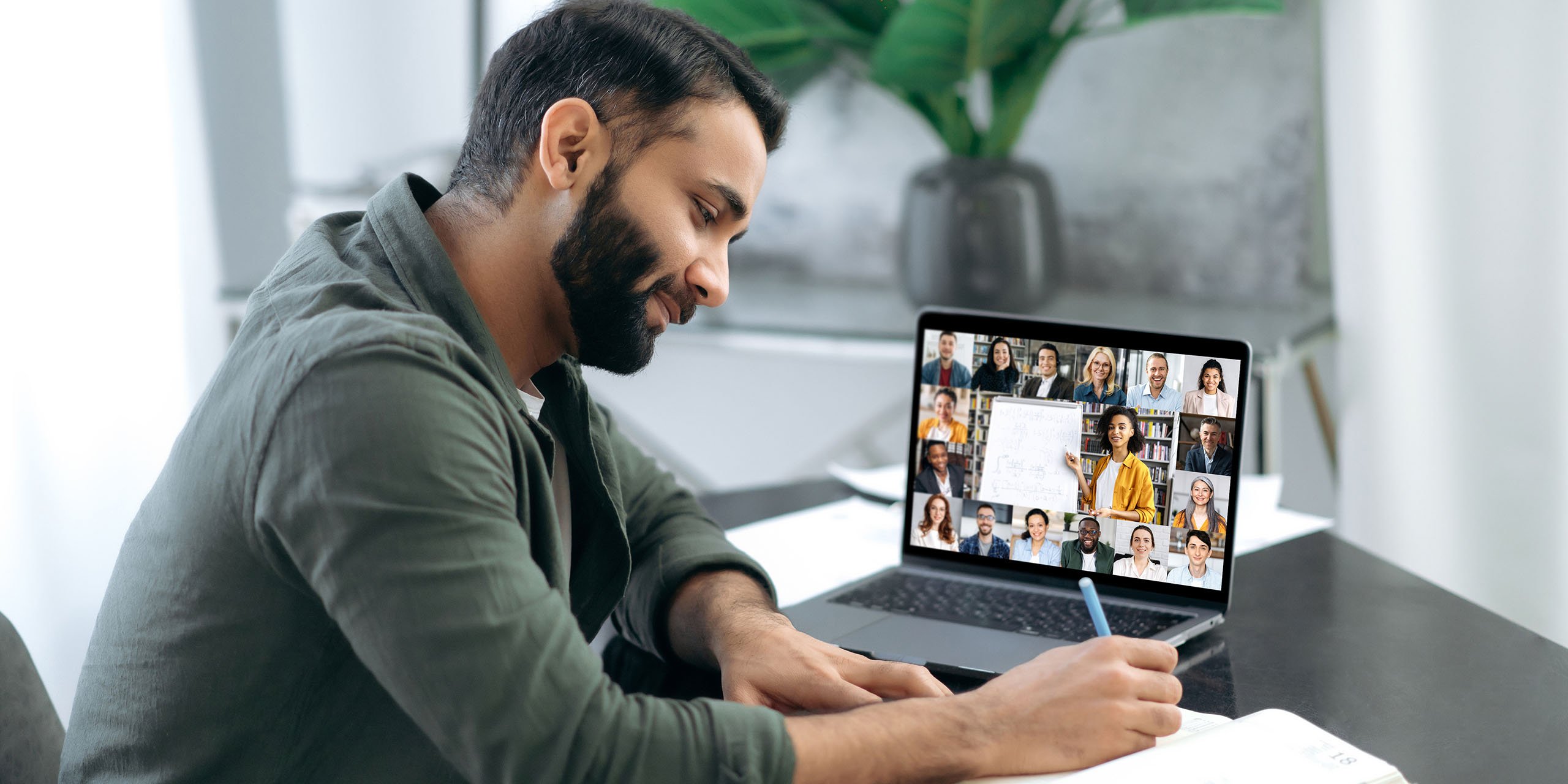 man takes note during elearning webinar session using custom elearning software