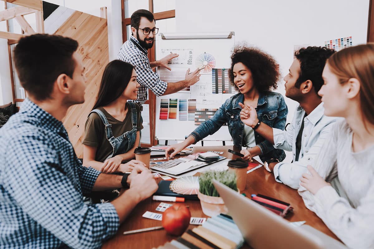 diverse team members collaborate on project during meeting