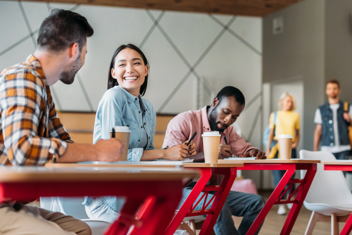 happy young students chat in classroom