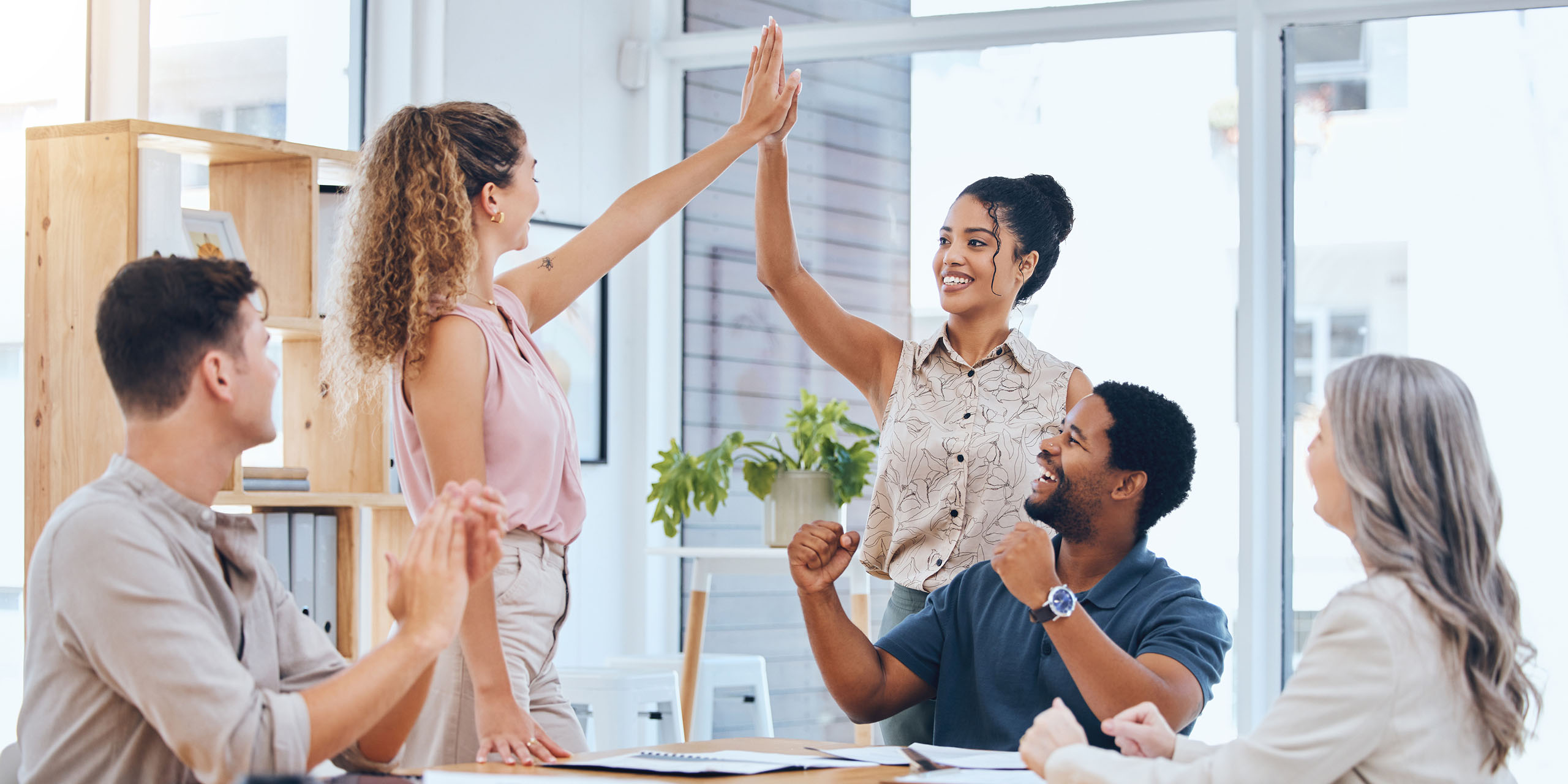 team celebrates achieving learning goals during meeting