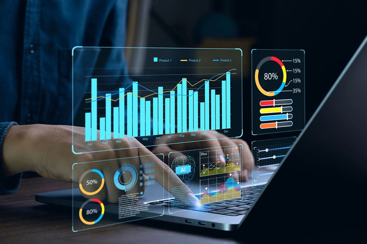 man works on laptop with overlay of graphs and charts tracking progress