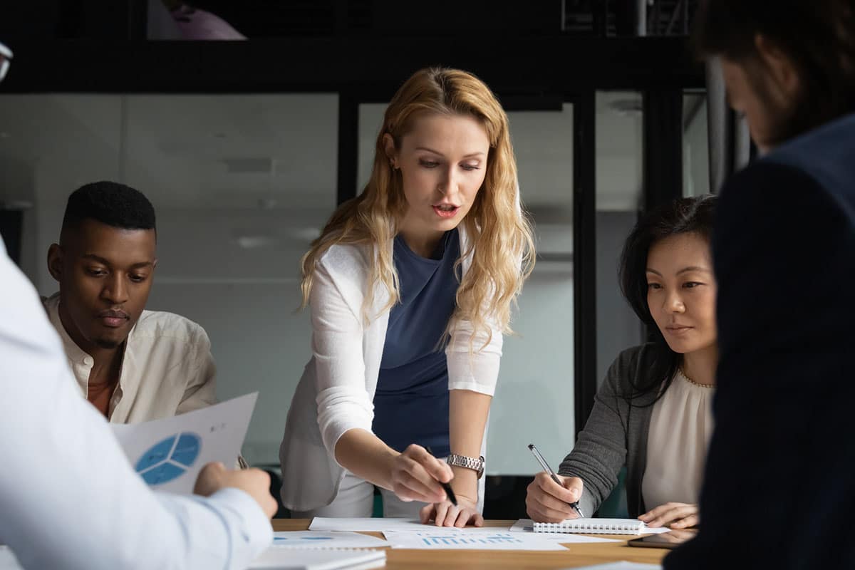 managers works with team assigning tasks to ensure employee goals align with company objectives