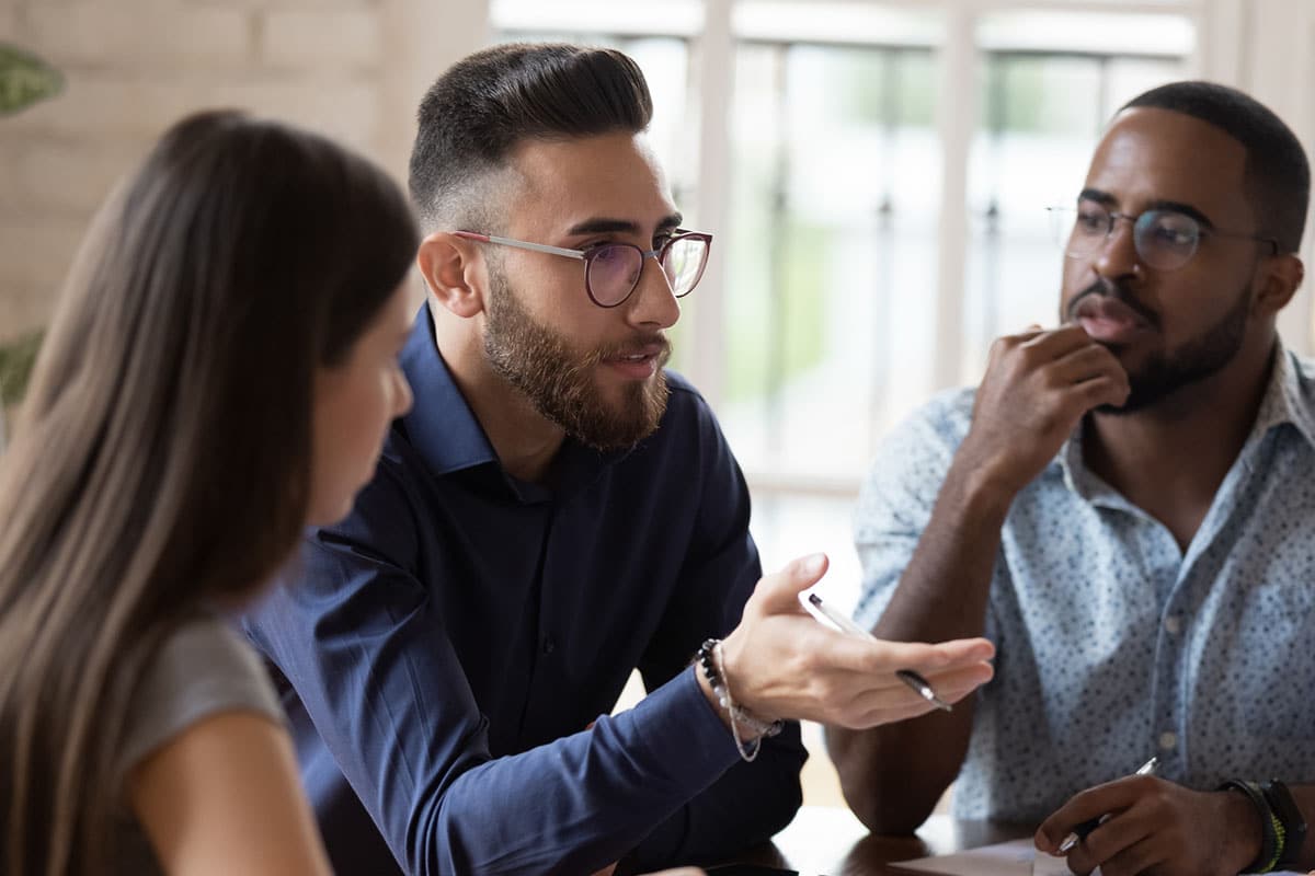 team of business professionals discuss approaches in negotiating conflict management style
