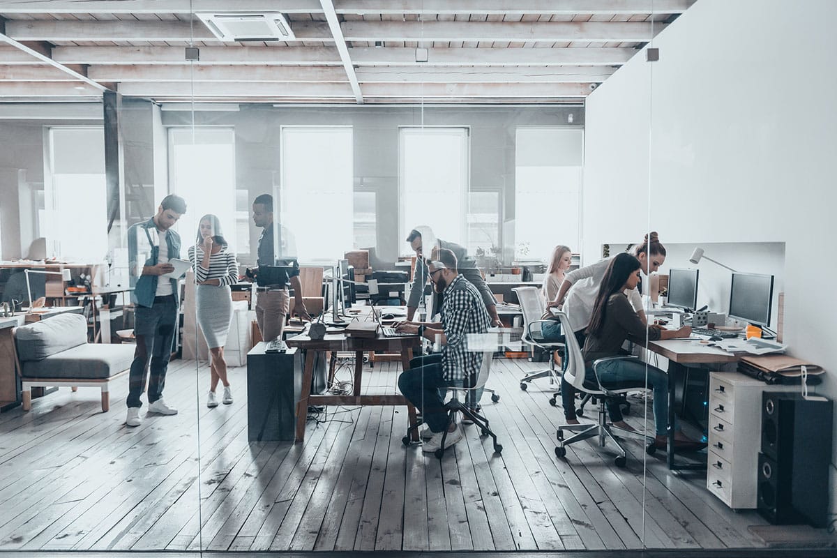 office environment with team members helping each other and disscussing things showing positive work culture