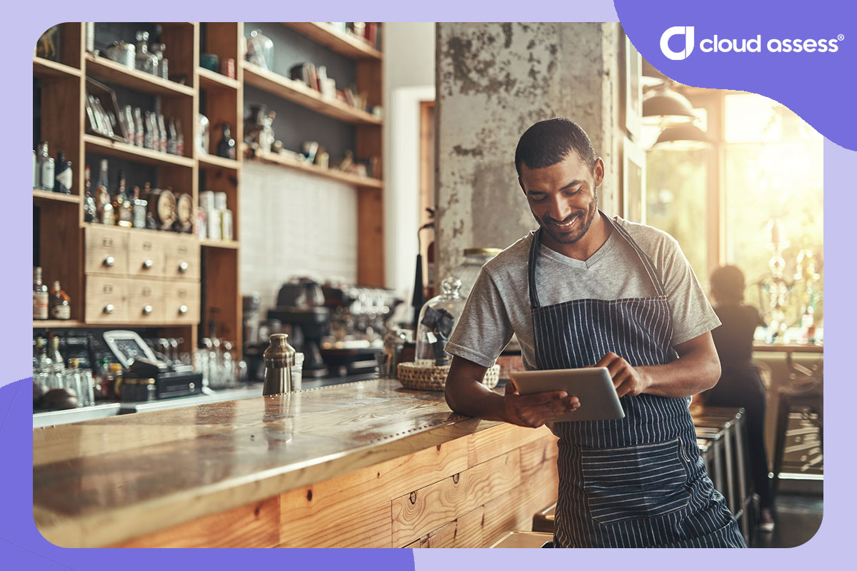 restaurant worker uses tablet to find courses for upskilling