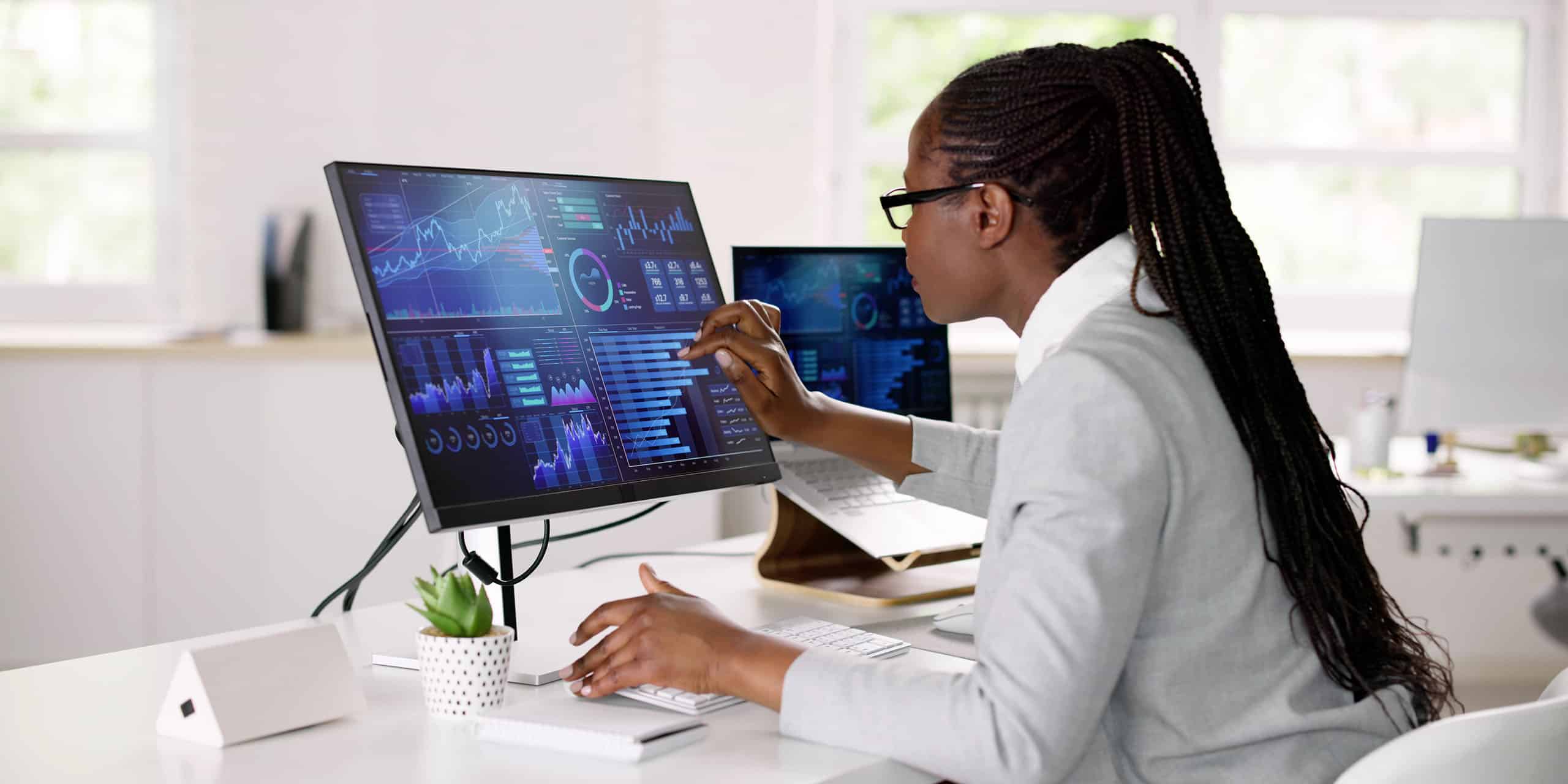 business woman reviews skill tracking data on large screen