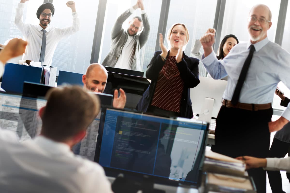 team employees celebrate success together showing positive reinforcement
