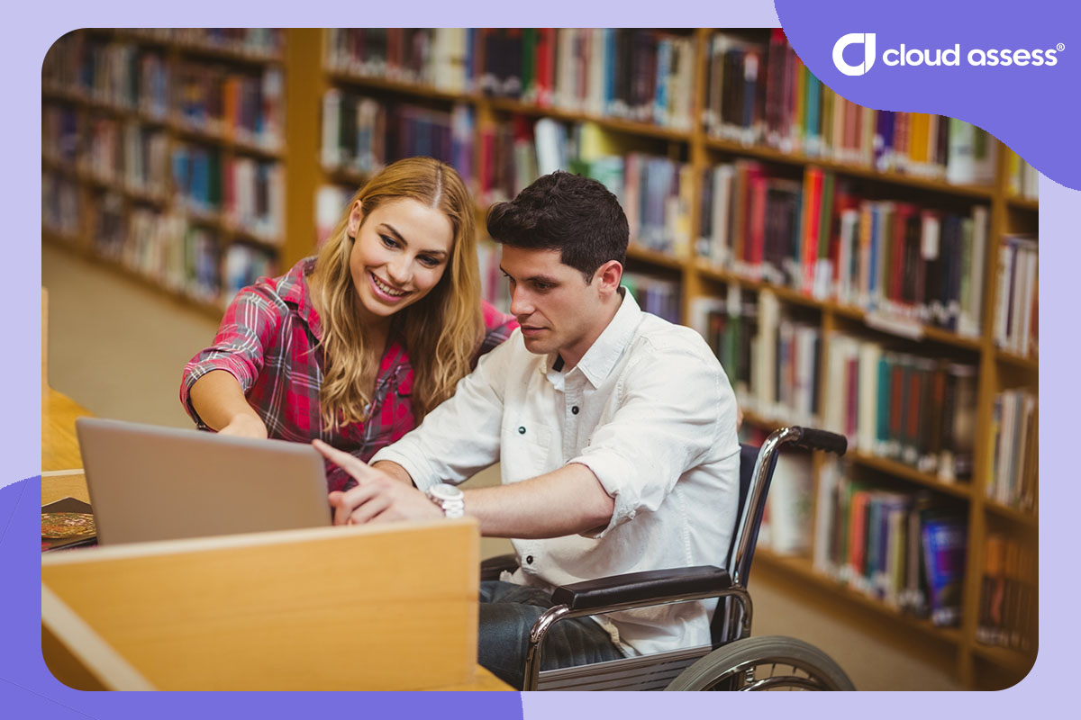 tutor helps student in wheelchair while in library