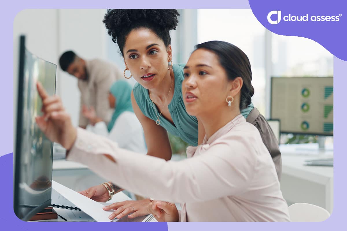 two business woman discuss graphs and statistics to develop learning and development budget