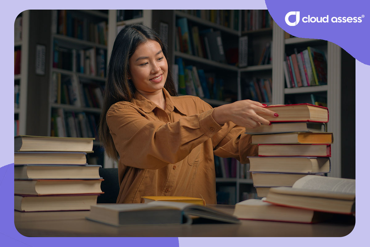 woman learns from reading in library with pile of open and closed books around her