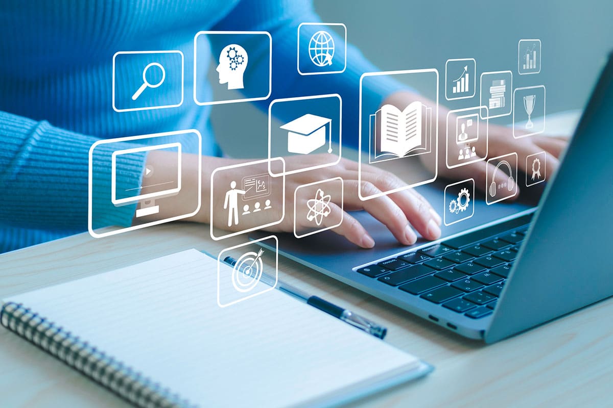 woman uses laptop to create elearning course with learning icon overlay on the image