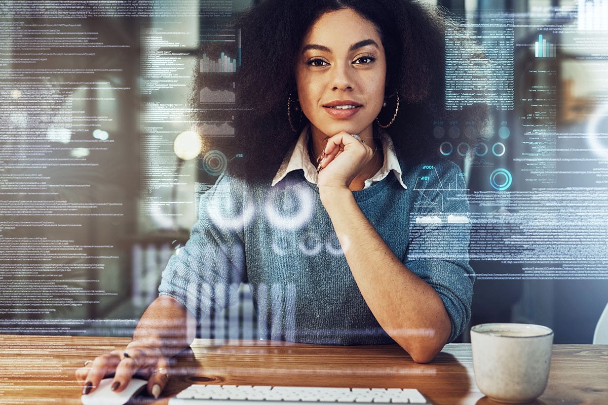 woman uses mouse and keyboard with code displayed over her image