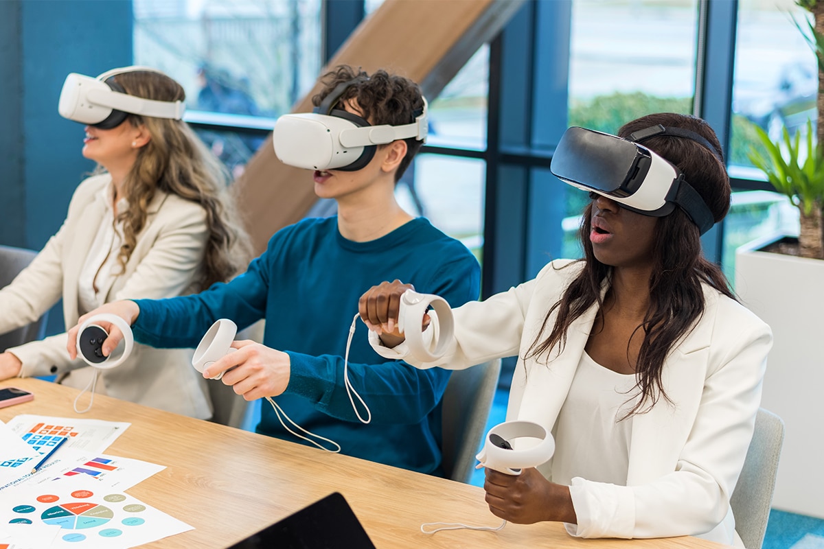 young professionals sit around table with virtual reality headsets demonstrating simulations as a microlearning example