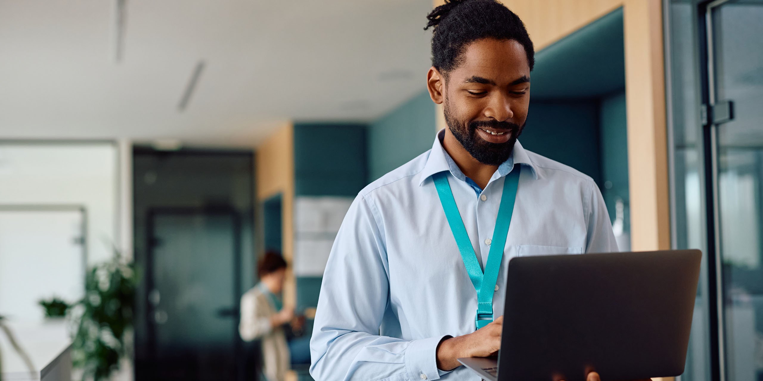 trainer accesses learner records on laptop while on the move