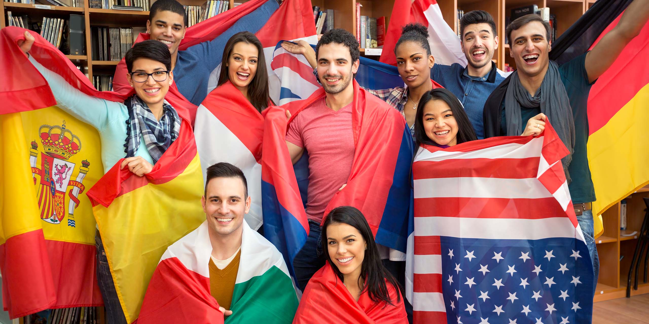 group of overseas learners pose with flags around them