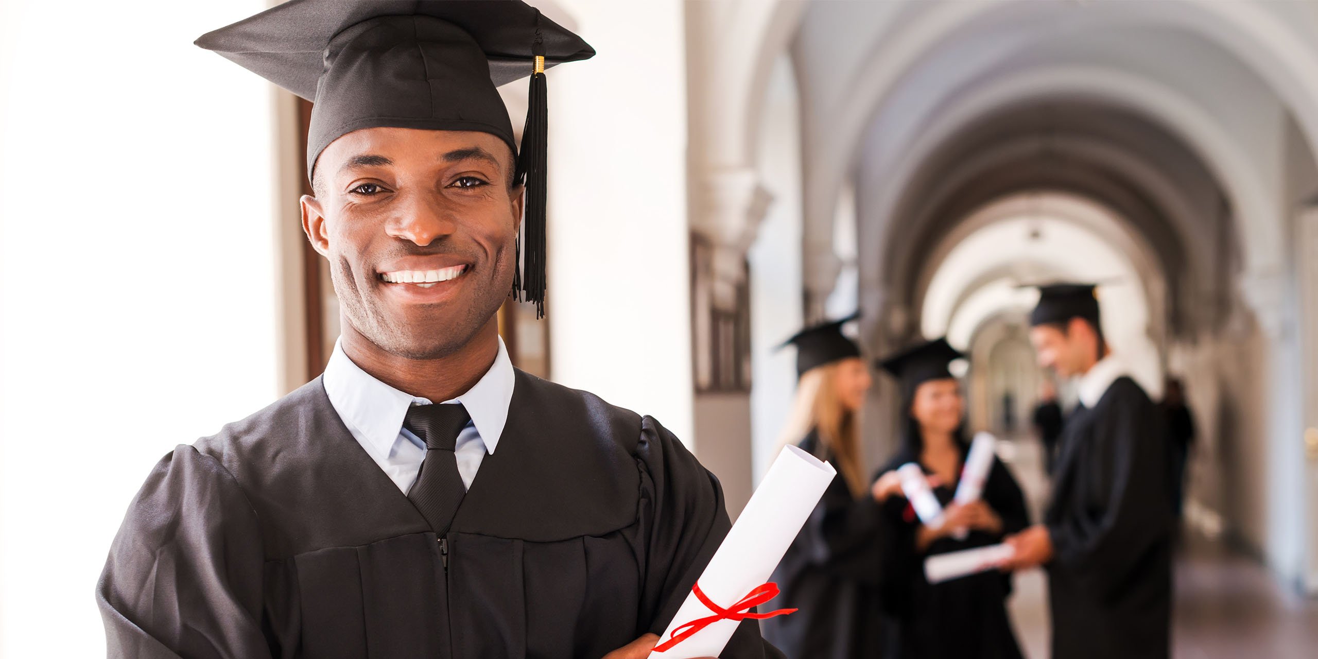 student completes qualification and poses with certificate