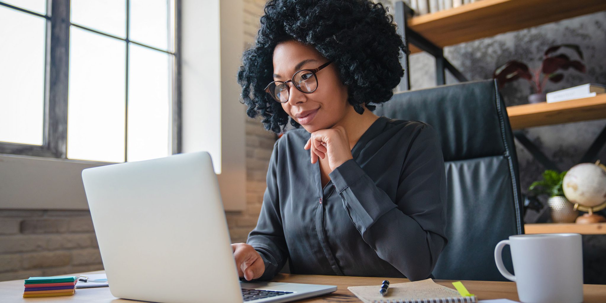 rto trainer works on professional development course on her laptop